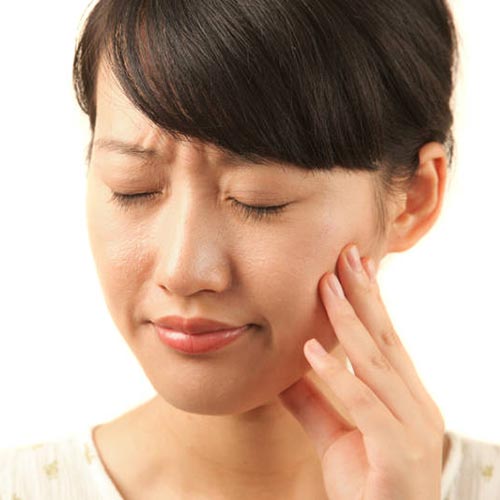 woman tooth pain hold mouth cheek