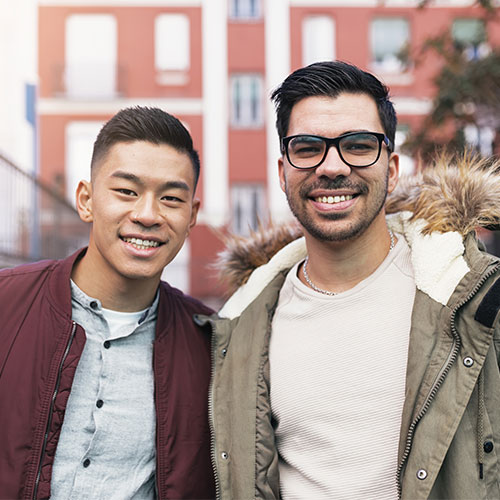 two friends smiling outside